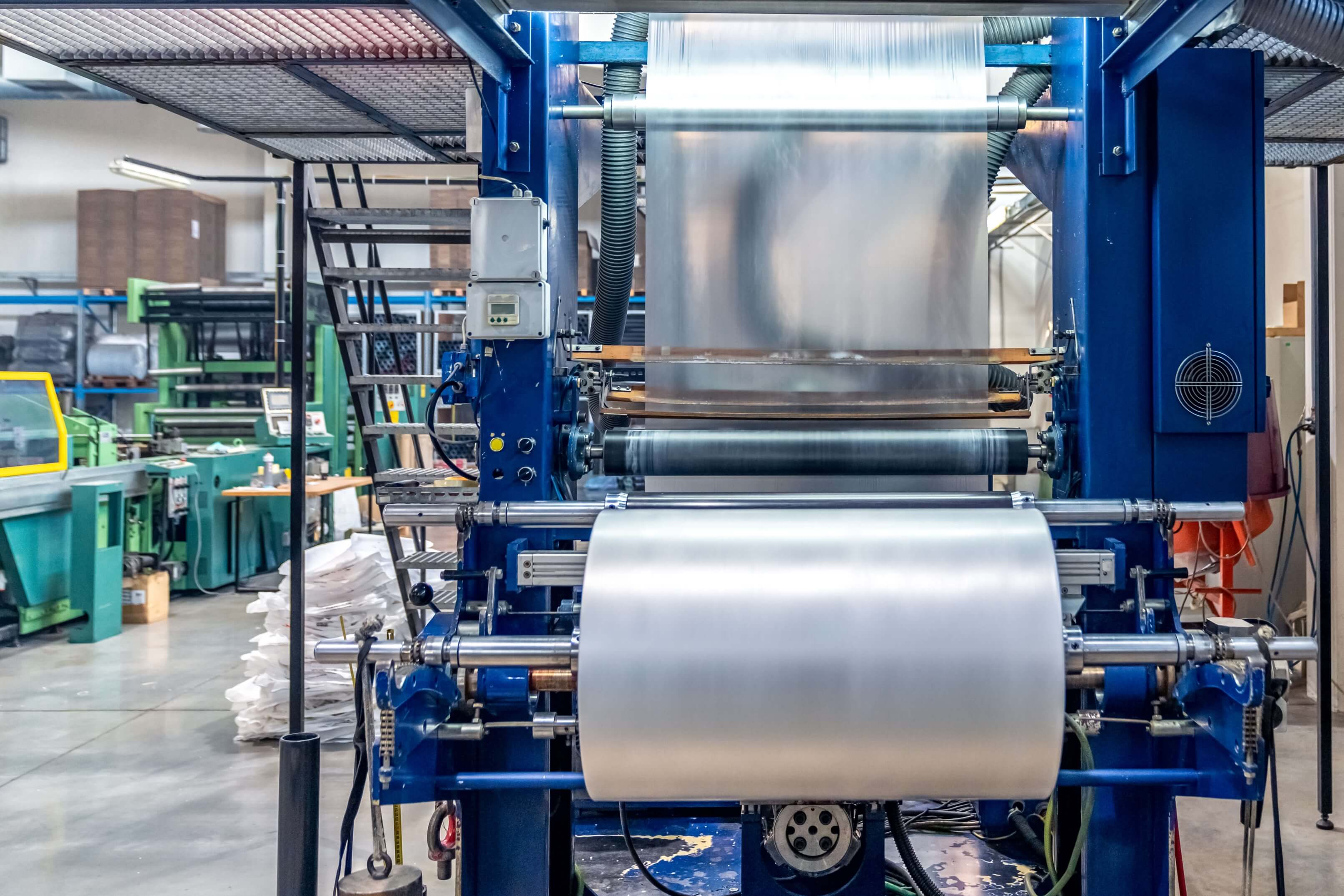 Industrial plastic bag production machine operating inside a manufacturing factory in Nigeria