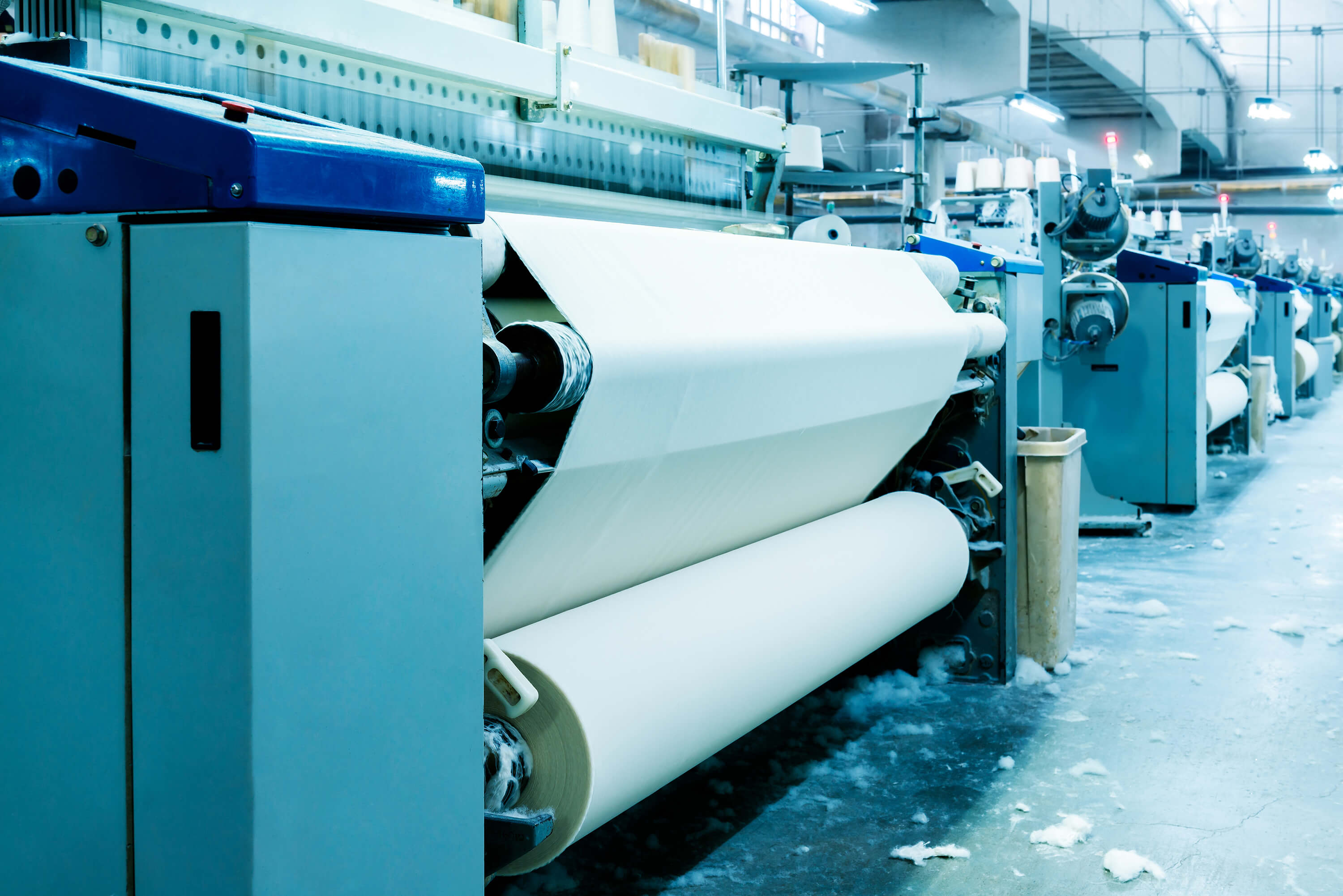 Plastic film production machine winding a white film roll