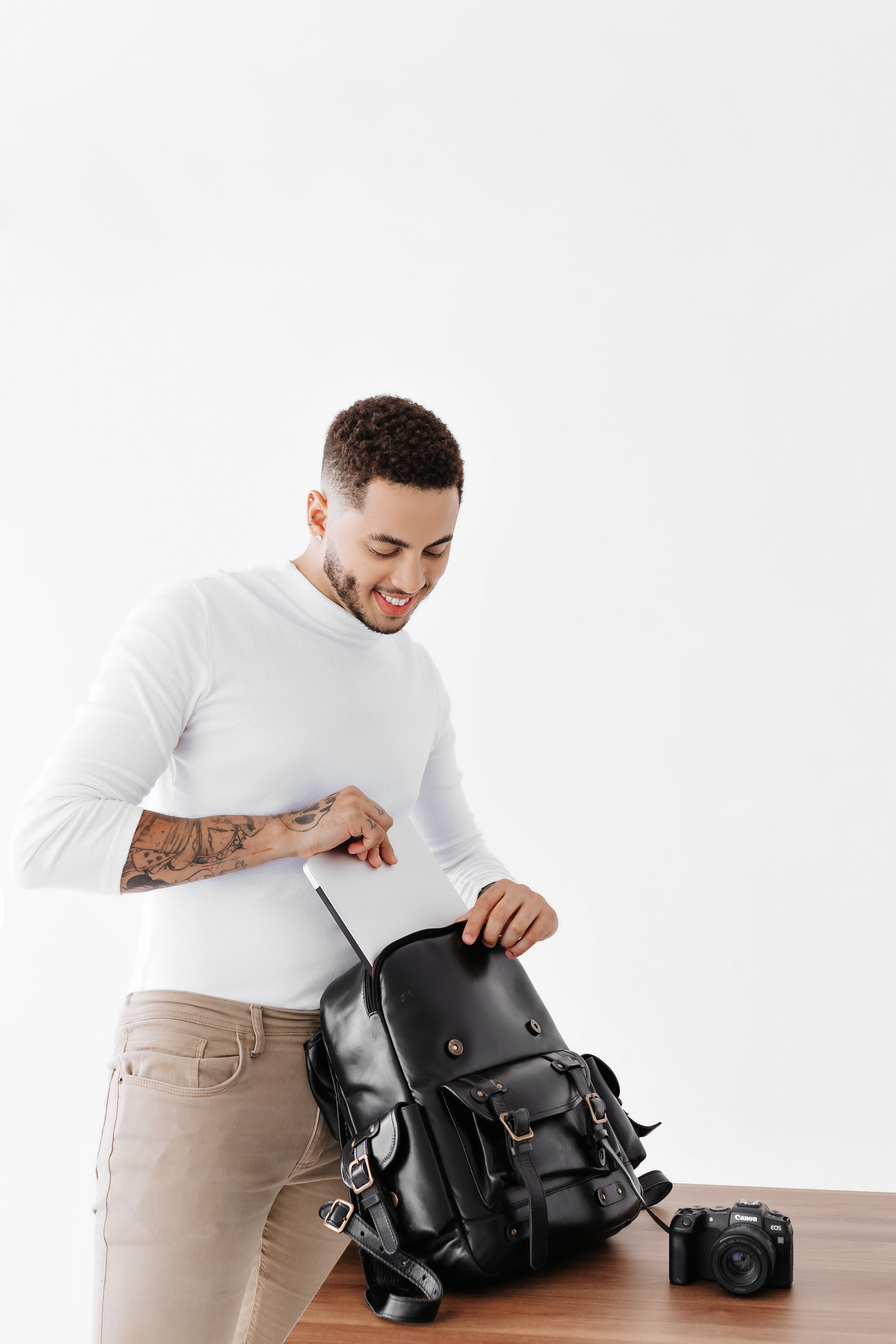 Man packing a black commuter backpack