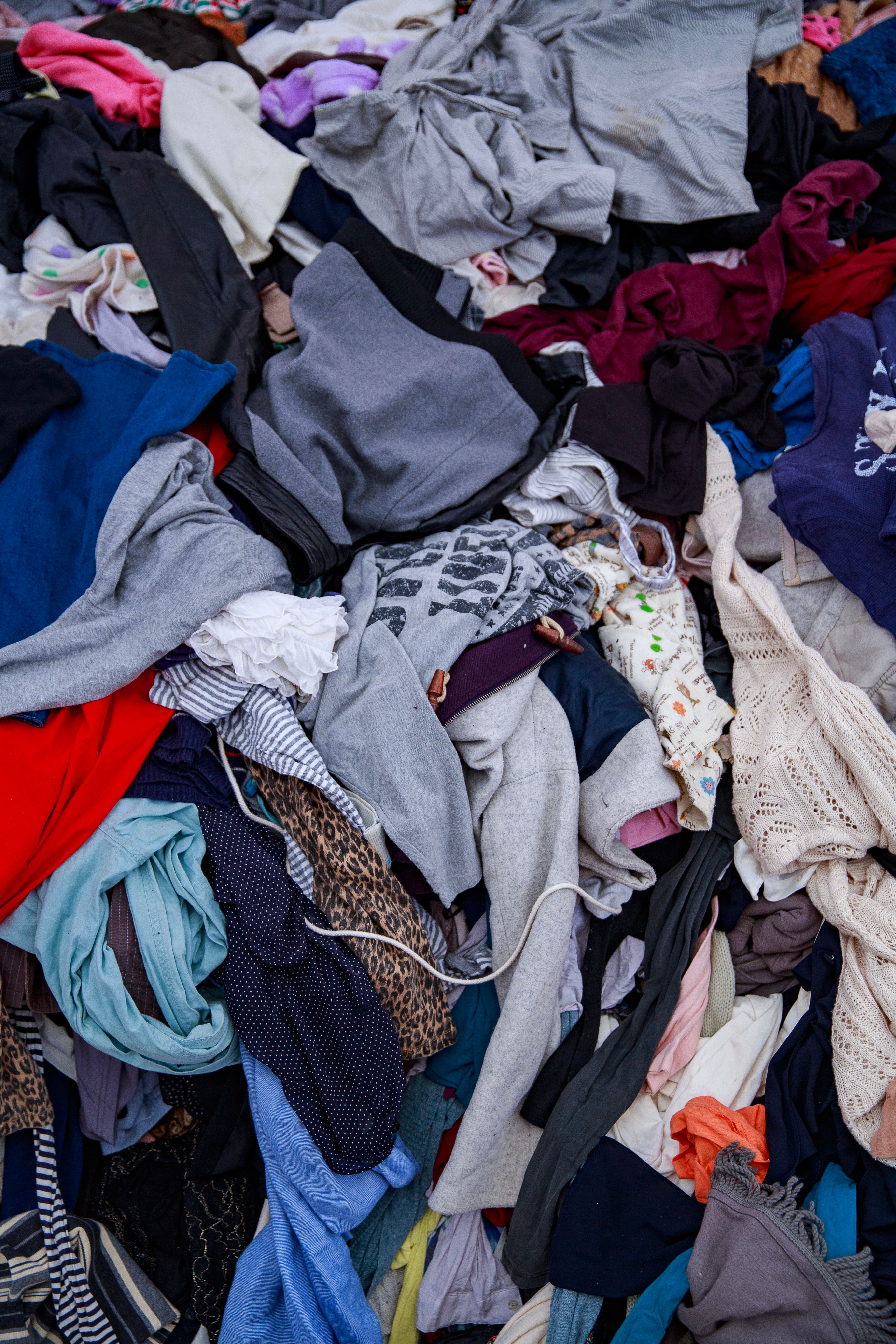 Large pile of mixed second-hand clothing