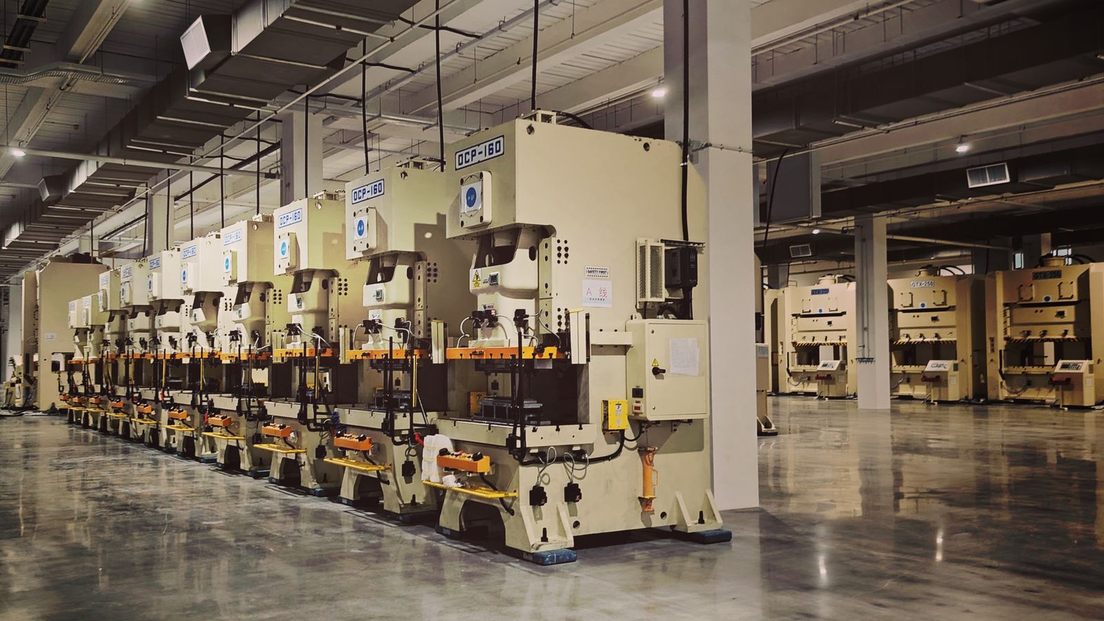 Factory floor with rows of industrial press machines