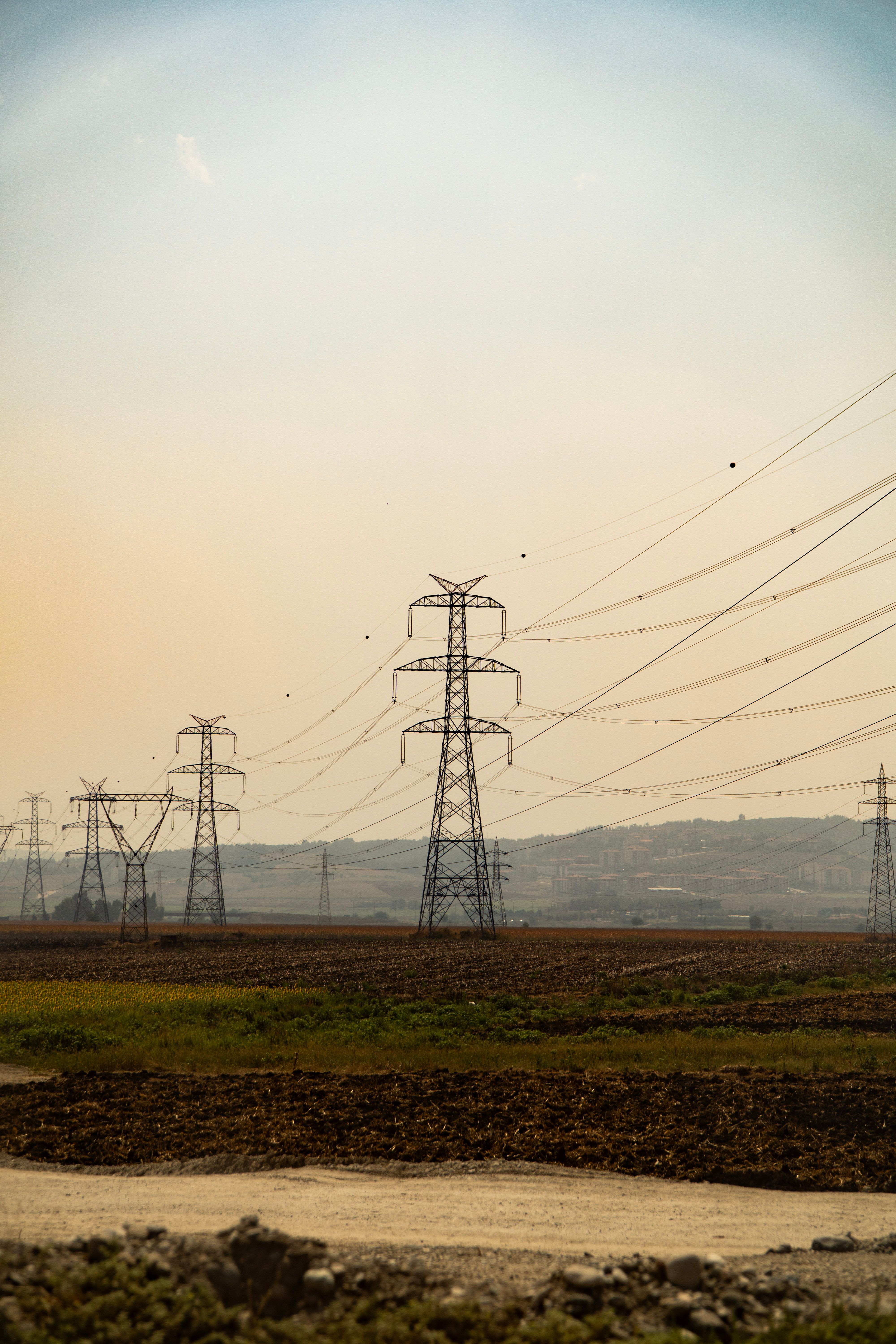 Electricity transmission pylons crossing open land