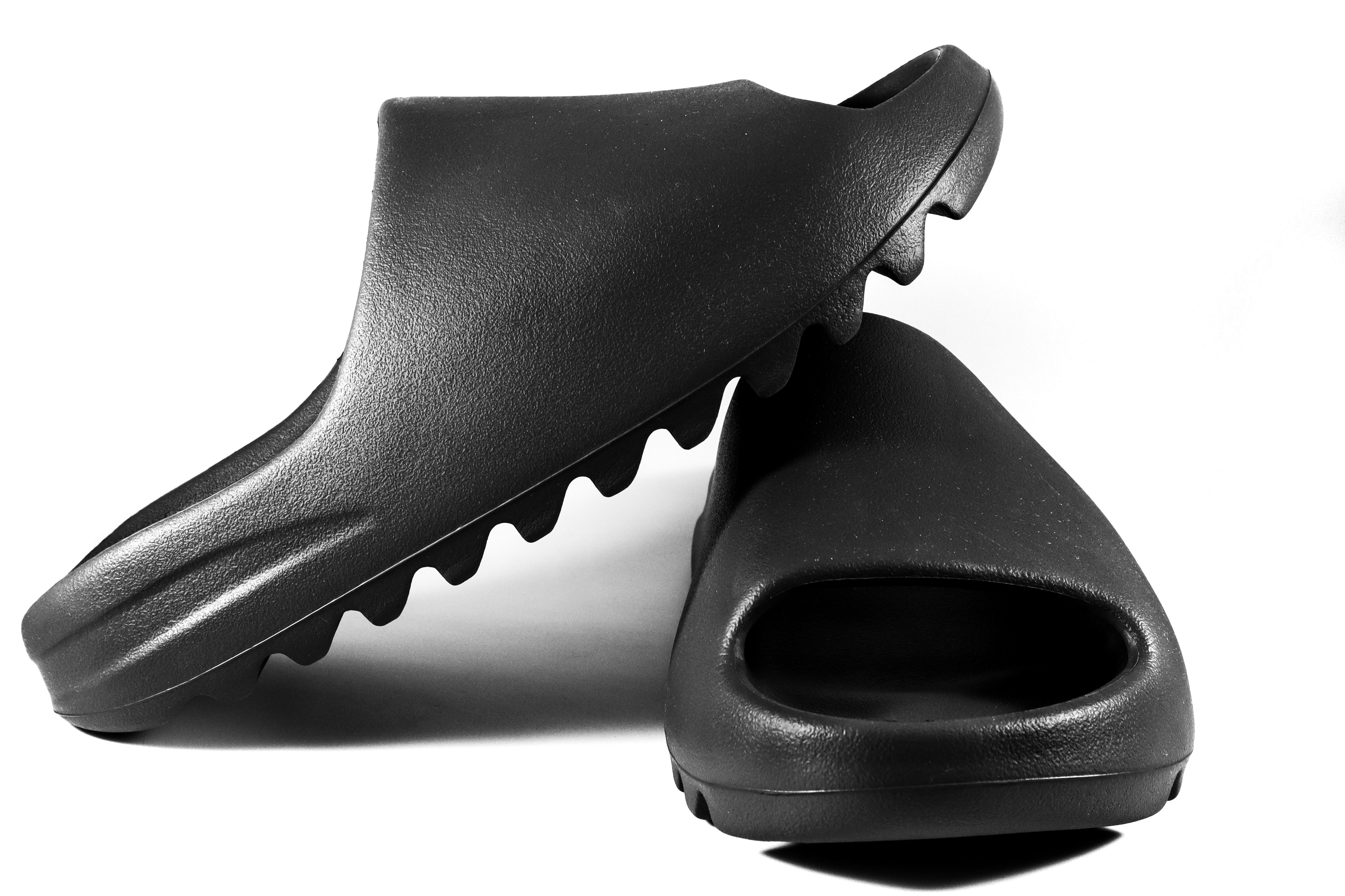 Pair of black moulded slide sandals