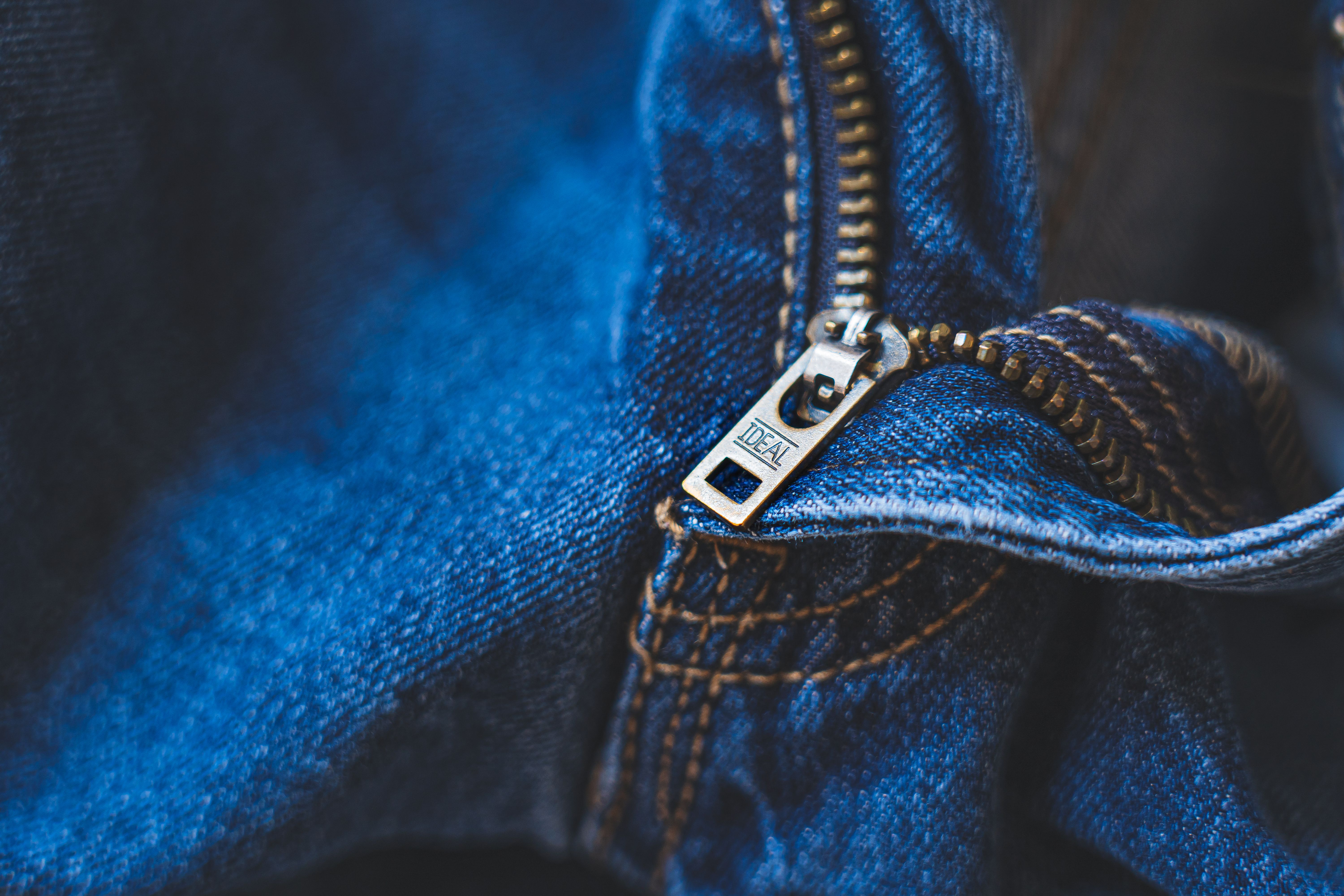 Close-up of a blue denim zip and pocket stitching