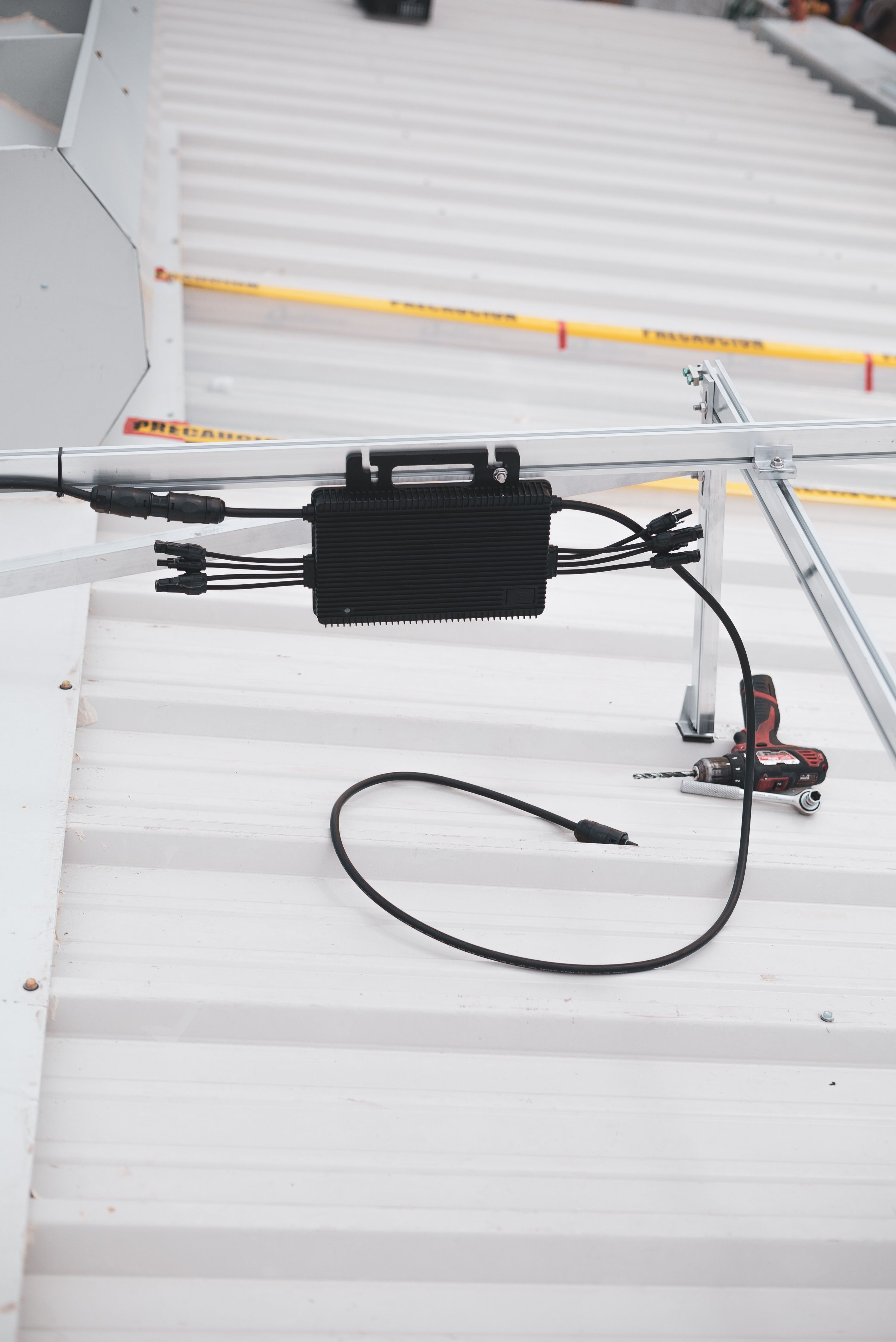 Microinverter mounted beneath a solar panel