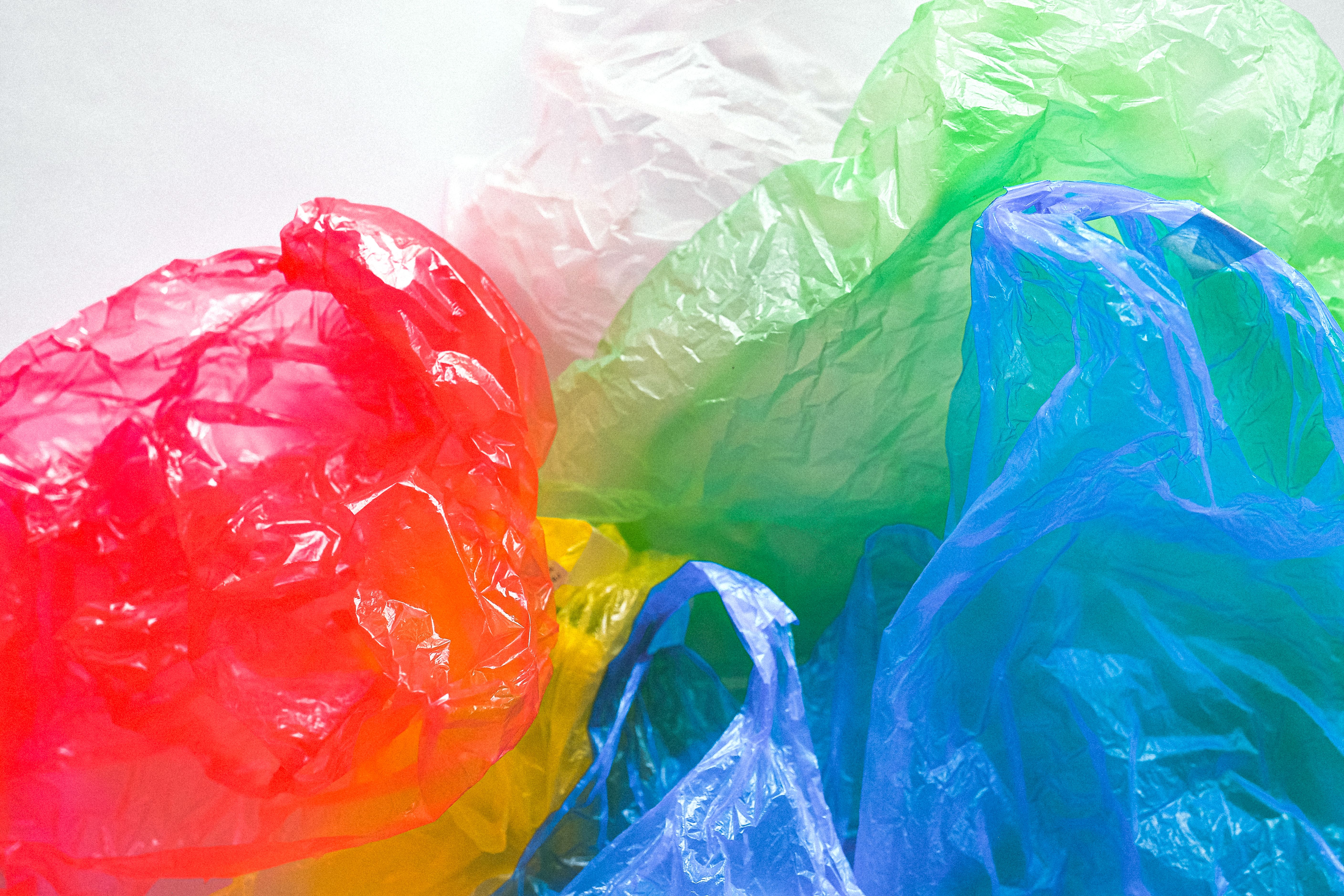 Coloured plastic carrier bags in red, green, blue and yellow