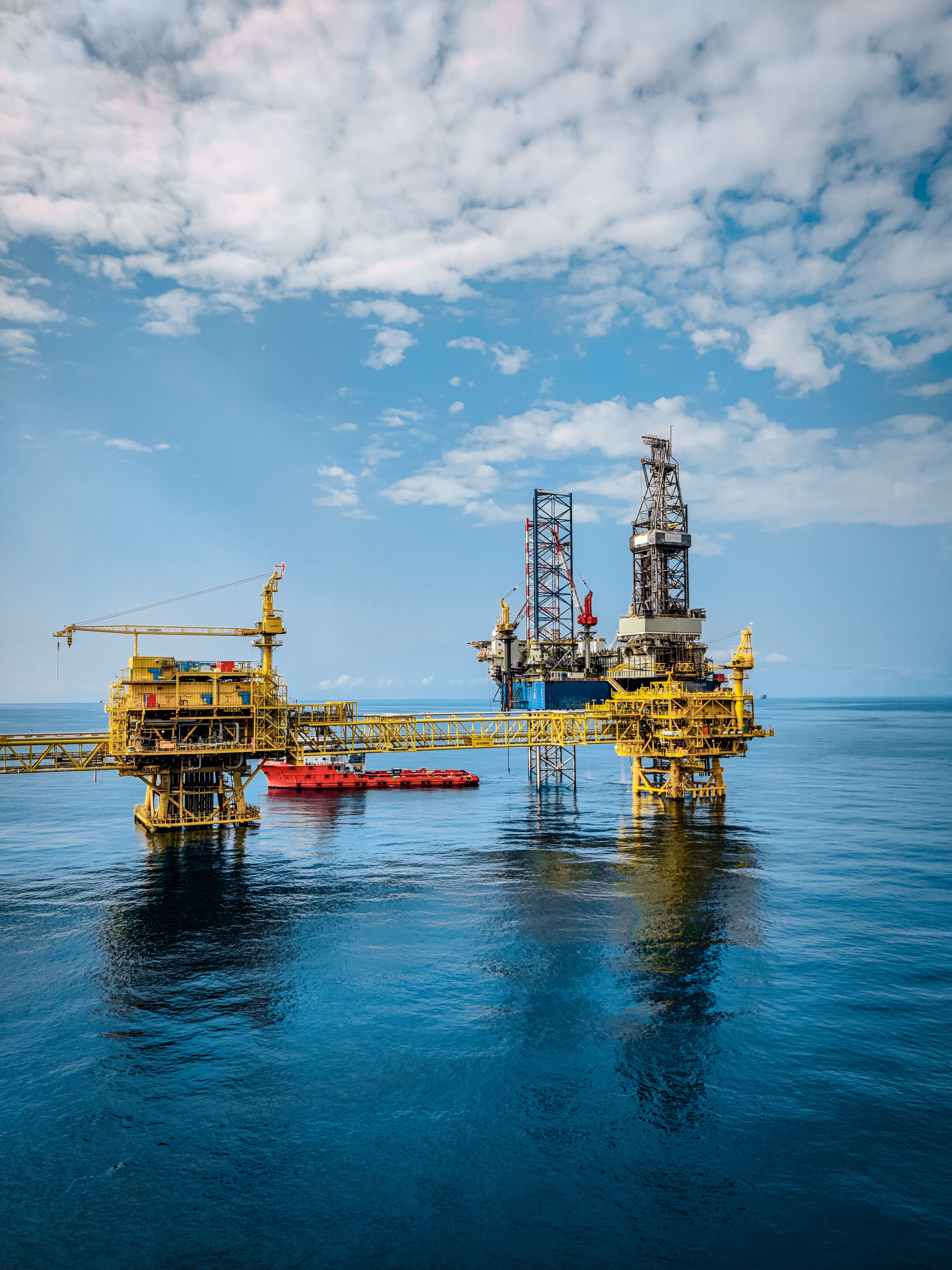 Offshore oil platform at sea under a blue sky