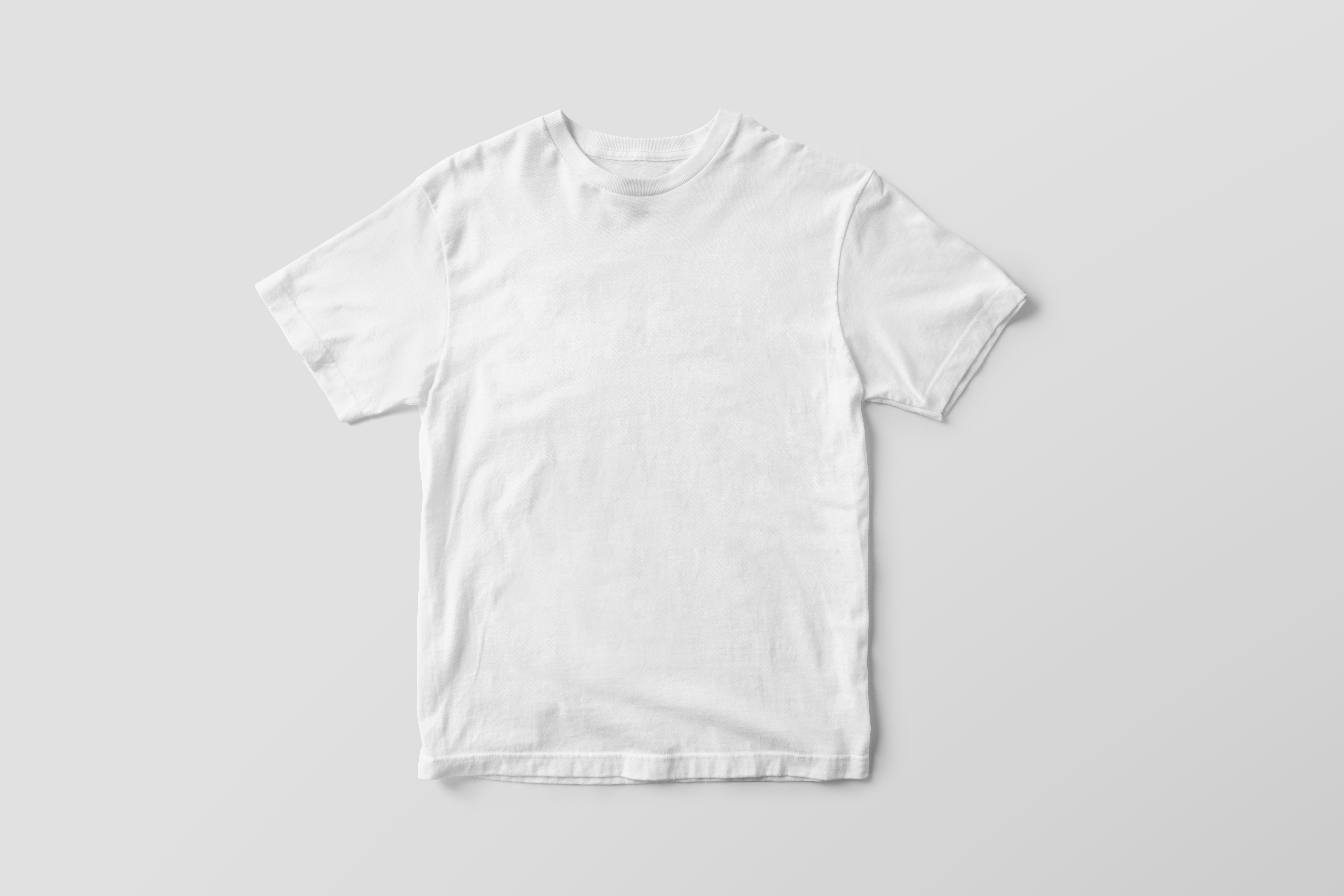 Plain white t-shirt laid flat on a grey background