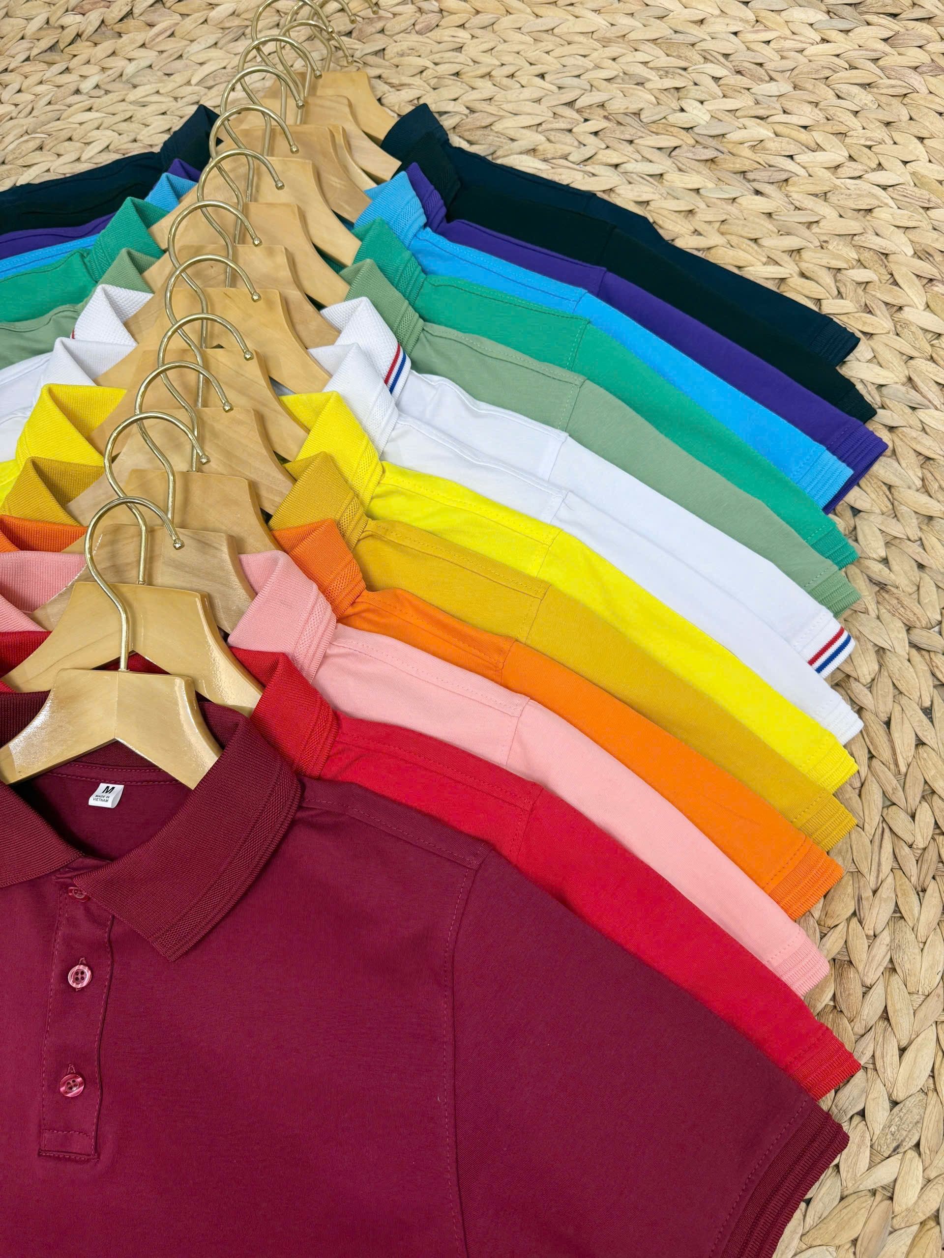 Stack of folded polo shirts in assorted colours