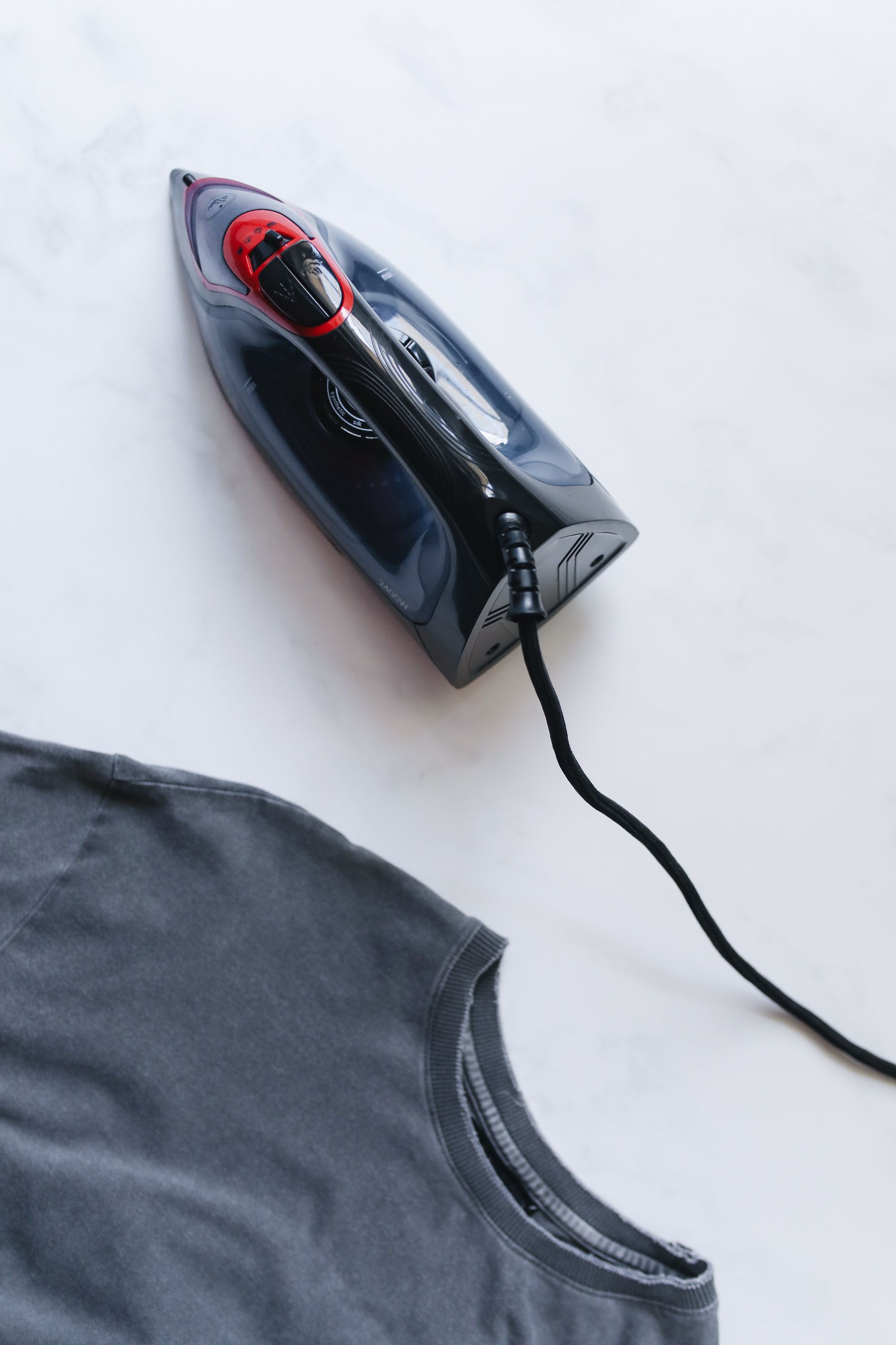 Hair clipper resting on a grey t-shirt