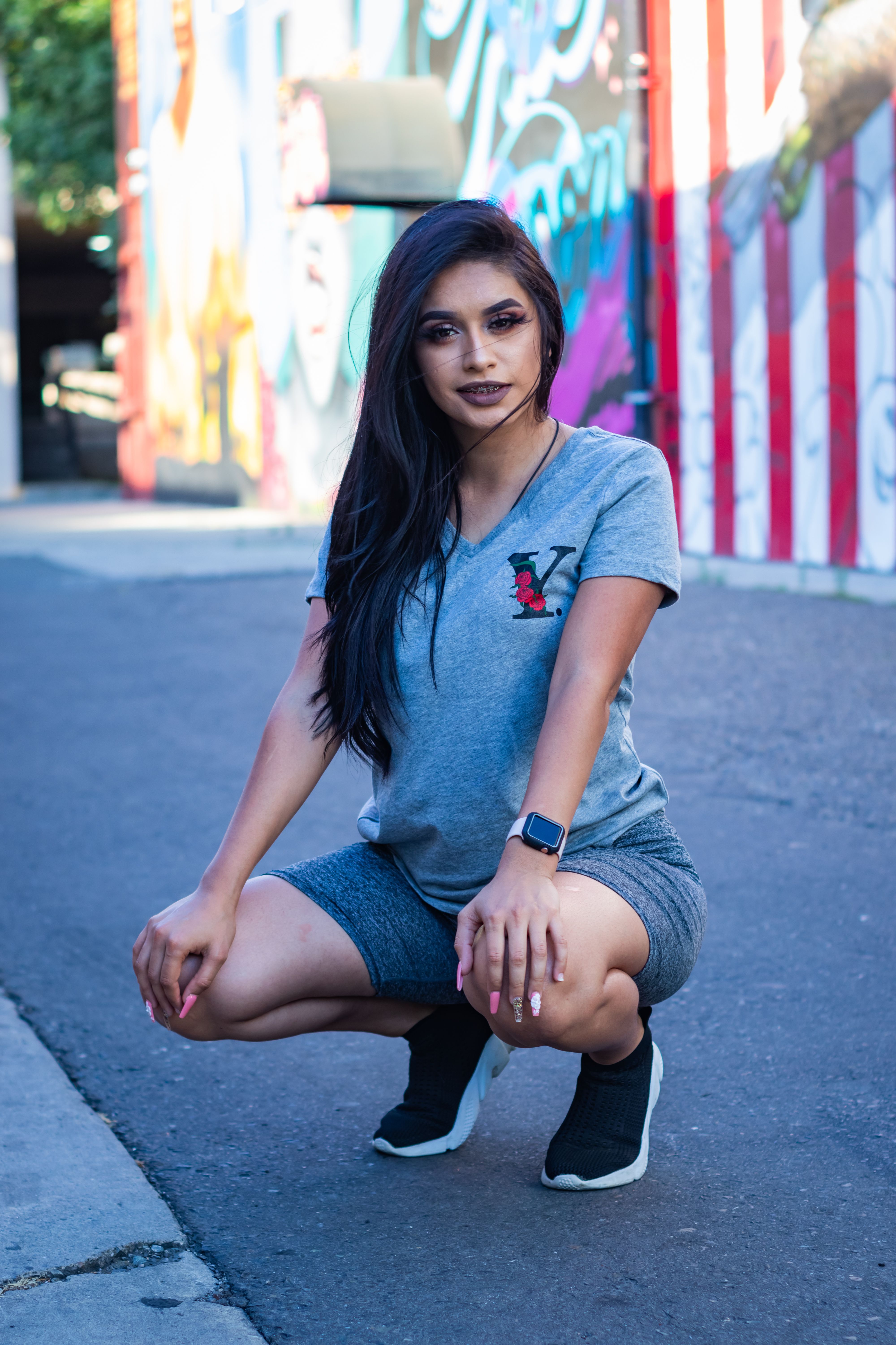 Woman wearing a t-shirt and denim shorts in a street