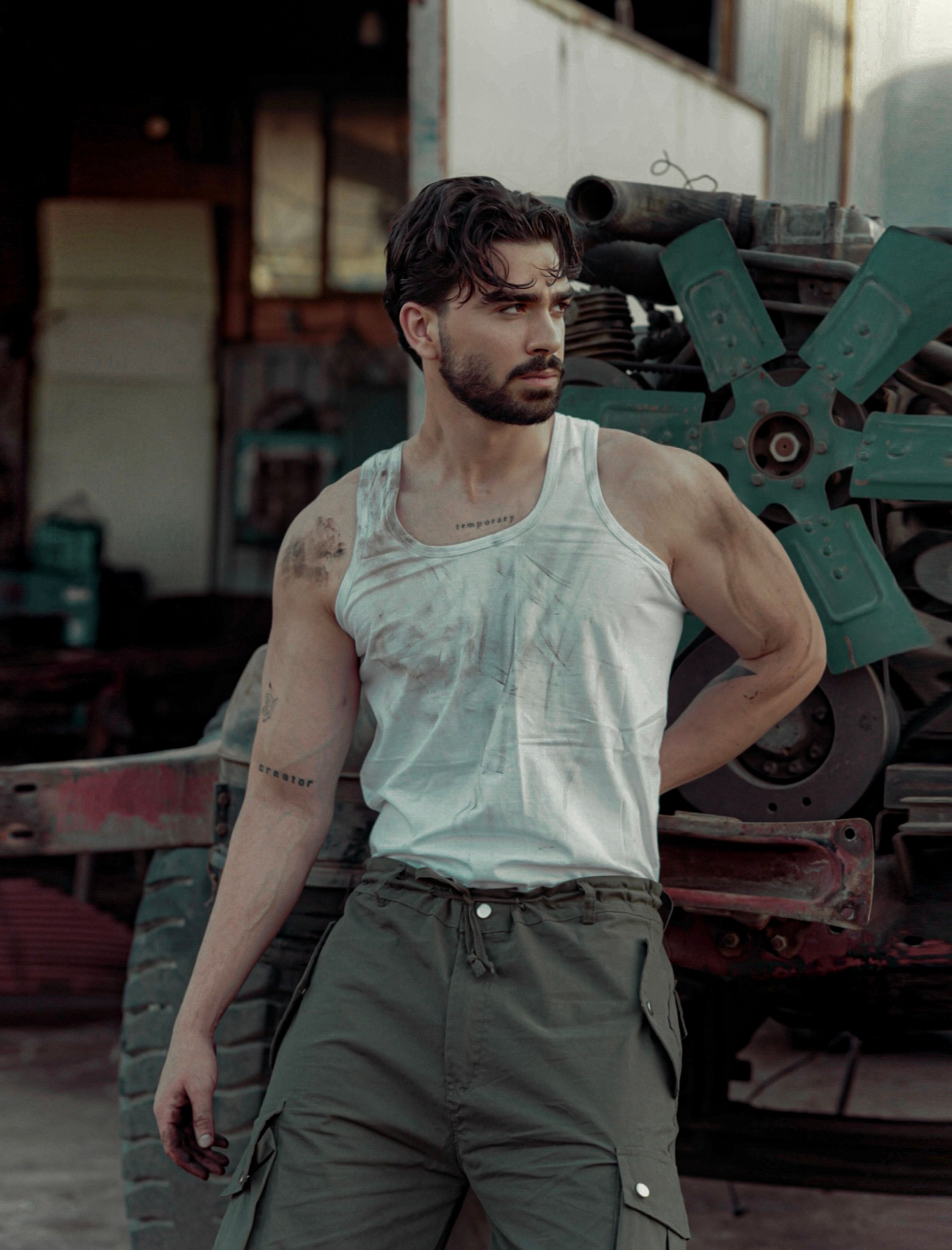 Man wearing a vest top in a workshop